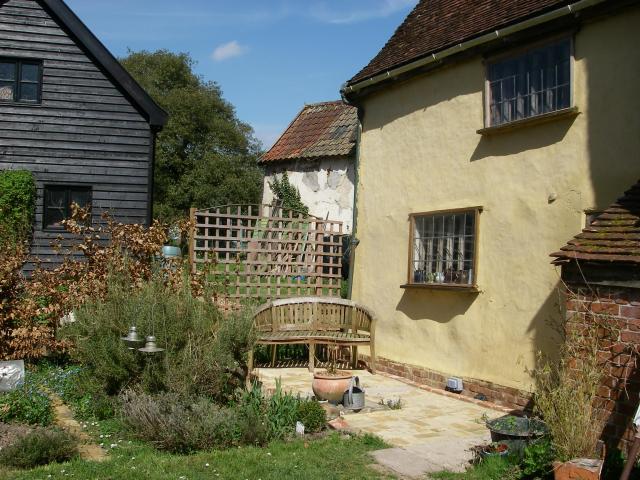 New brick patio, with the well protected by a steel over with limestone slabs on top.