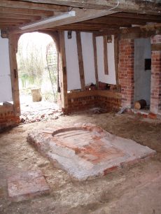 The brewing hearth and the door to the demolished part of the building.