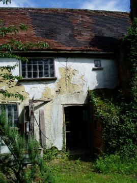 The back door, before any work was done, also showing the smoked-stained replacement tiles.