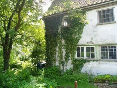 As we found it: the west wall, with the stone sink bottom right.