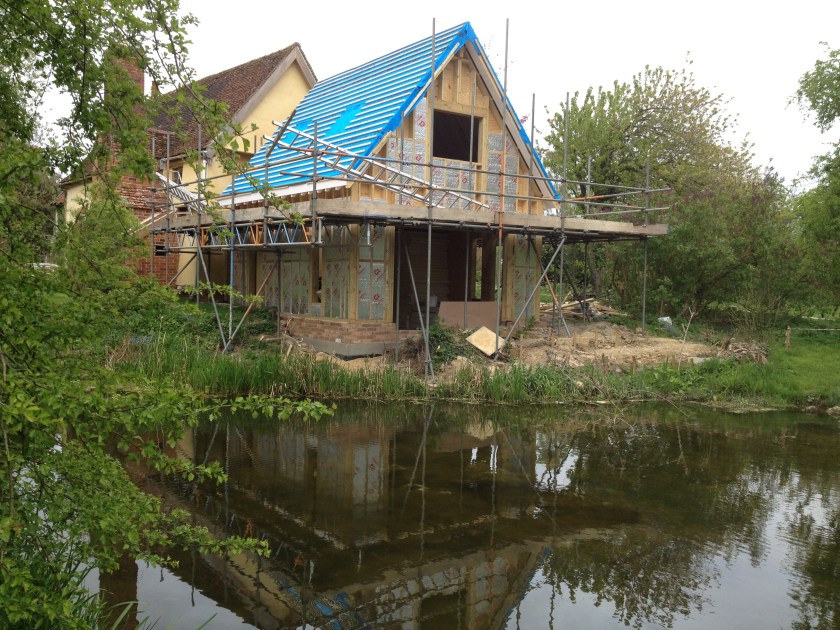 The first layer ofroof insulation is added and protected with a plastic membrane