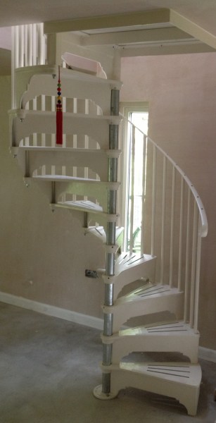 The steel and cast aluminium spiral stairs made by Cottage Craft Spirals just installed - the post has yet to be painted and the screwholes on the handrail will be filled.